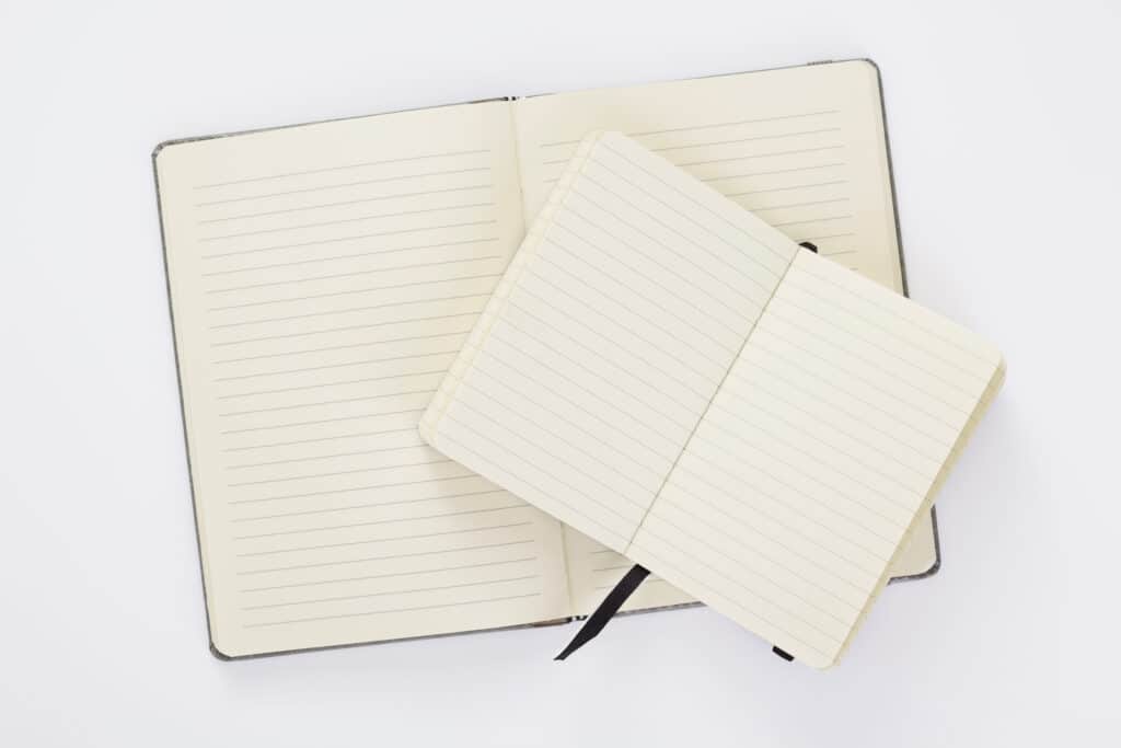 Lined interior paper in planners laying flat on a table