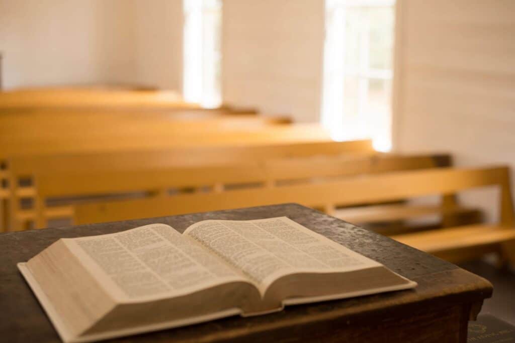 Open Bible laying on a podium in a church setting