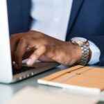 Influencer typing on laptio