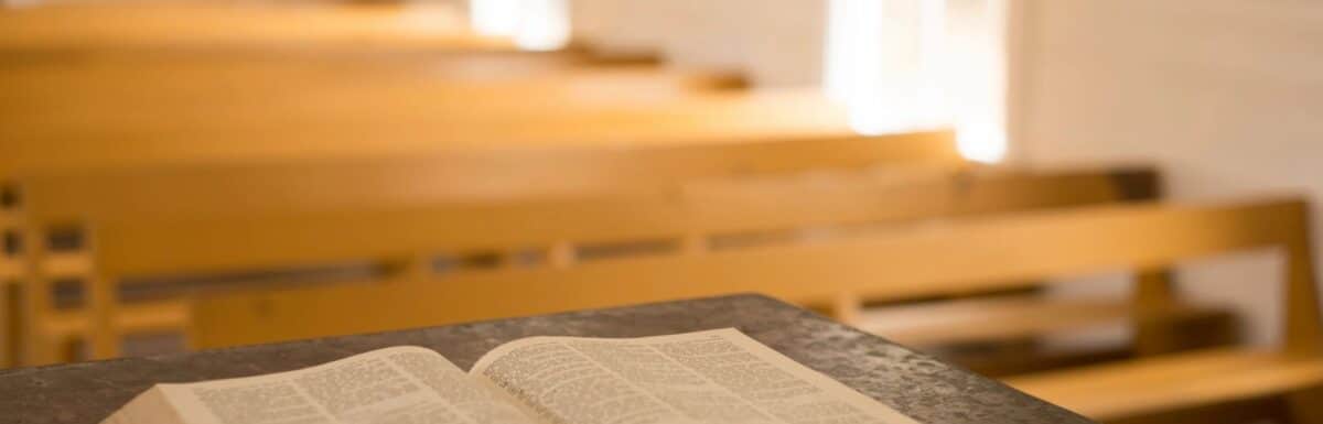 Opened Bible laying on podium inside a church