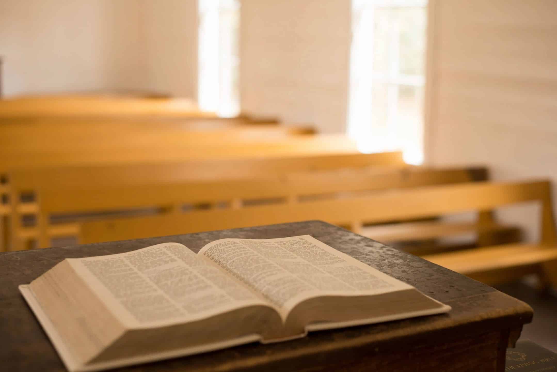 Opened Bible laying on podium inside a church
