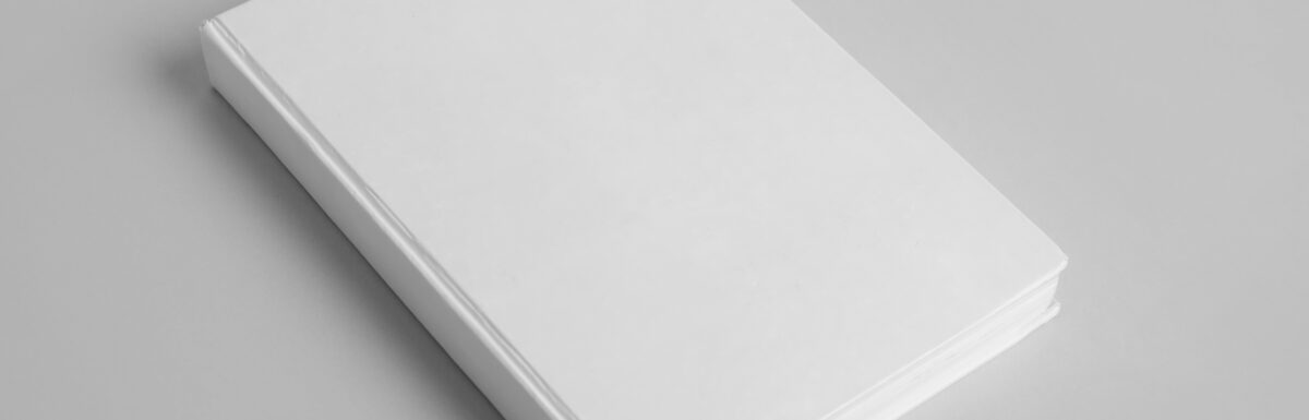 Blank white book laying on table. Overseas white dummy sample for clients.