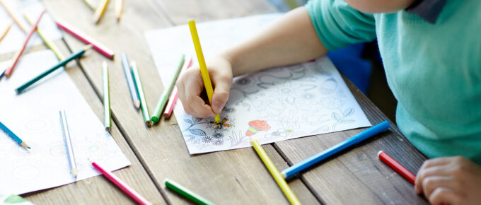 Children Coloring with markers on coloring page