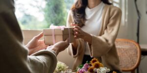 Woman handing Man a gift